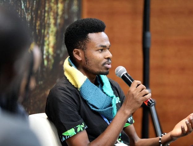 Youth activist Kaluki Paul Mutuku speaking into a microphone